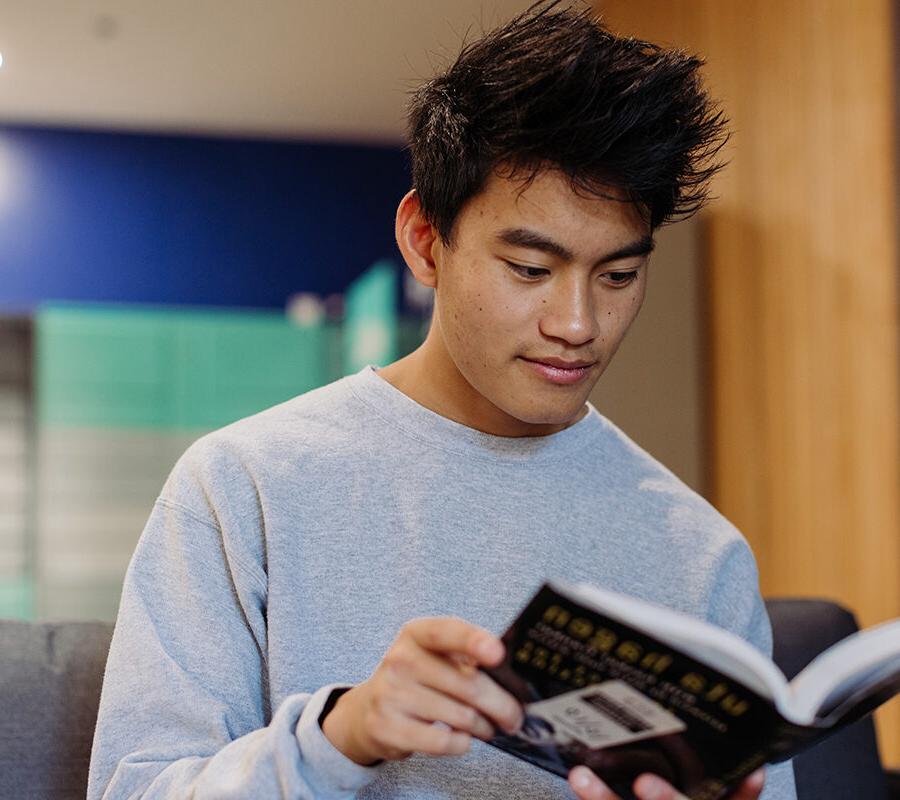 History student reads a book in the dorms.