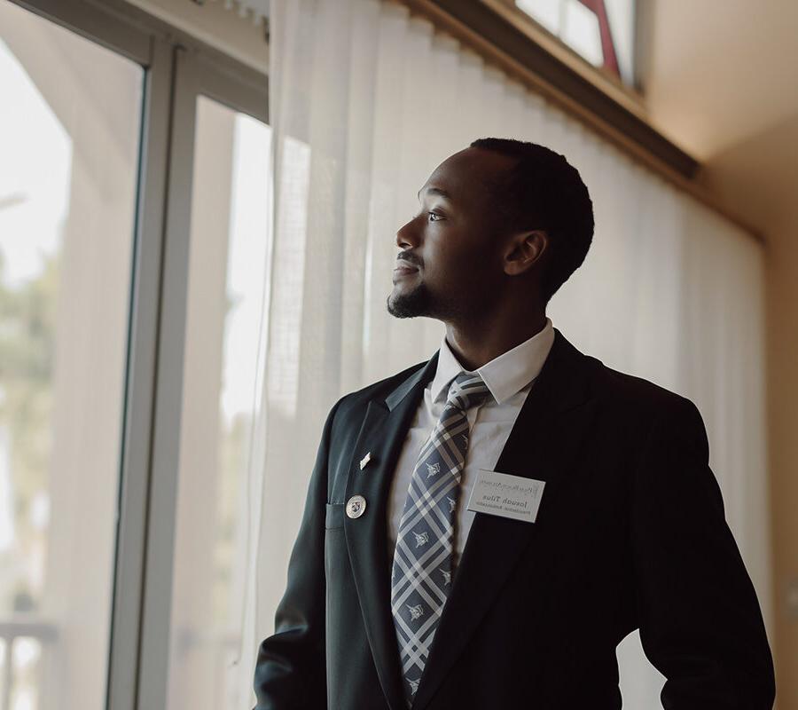 Business student looks out of window at Palm Beach Atlantic University